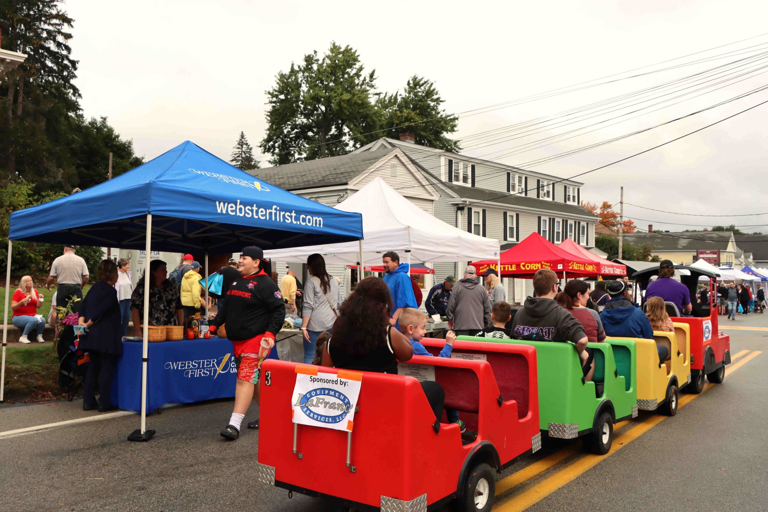 Children's Train ride driving by Webster First vendor booth at Douglas Oktoberfest 2023
