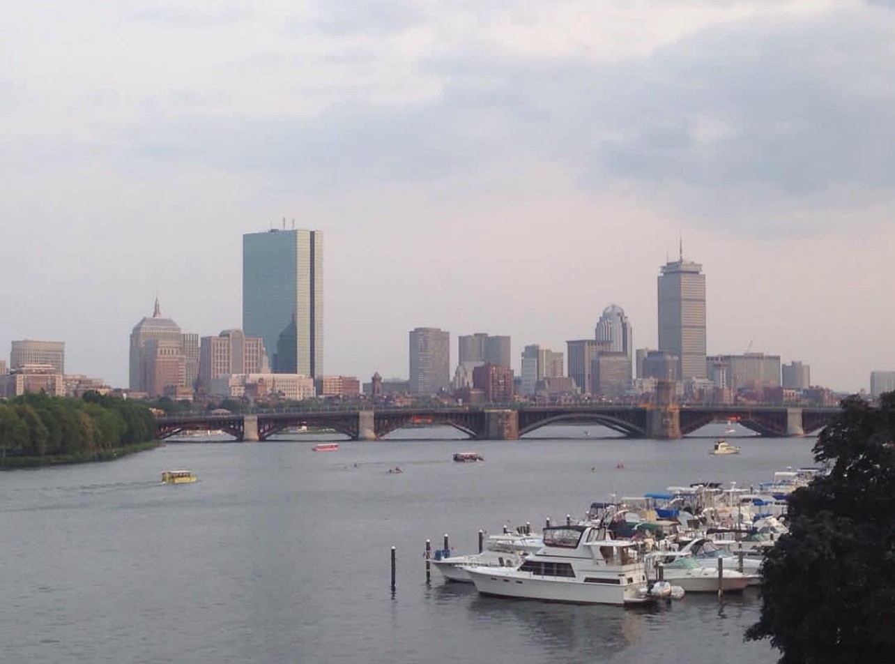 Boston skyline on a clear day over Charles River with boats on the water